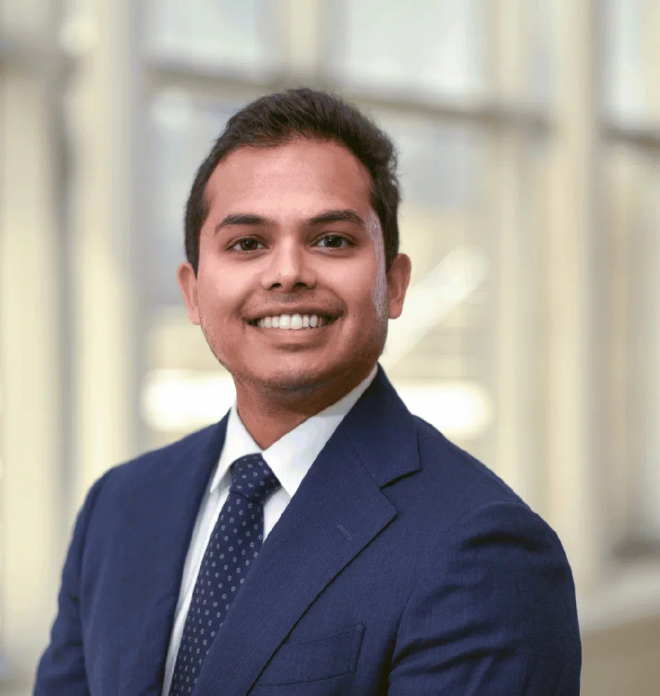 Dr. Amit Reddy smiling in a navy suit and tie